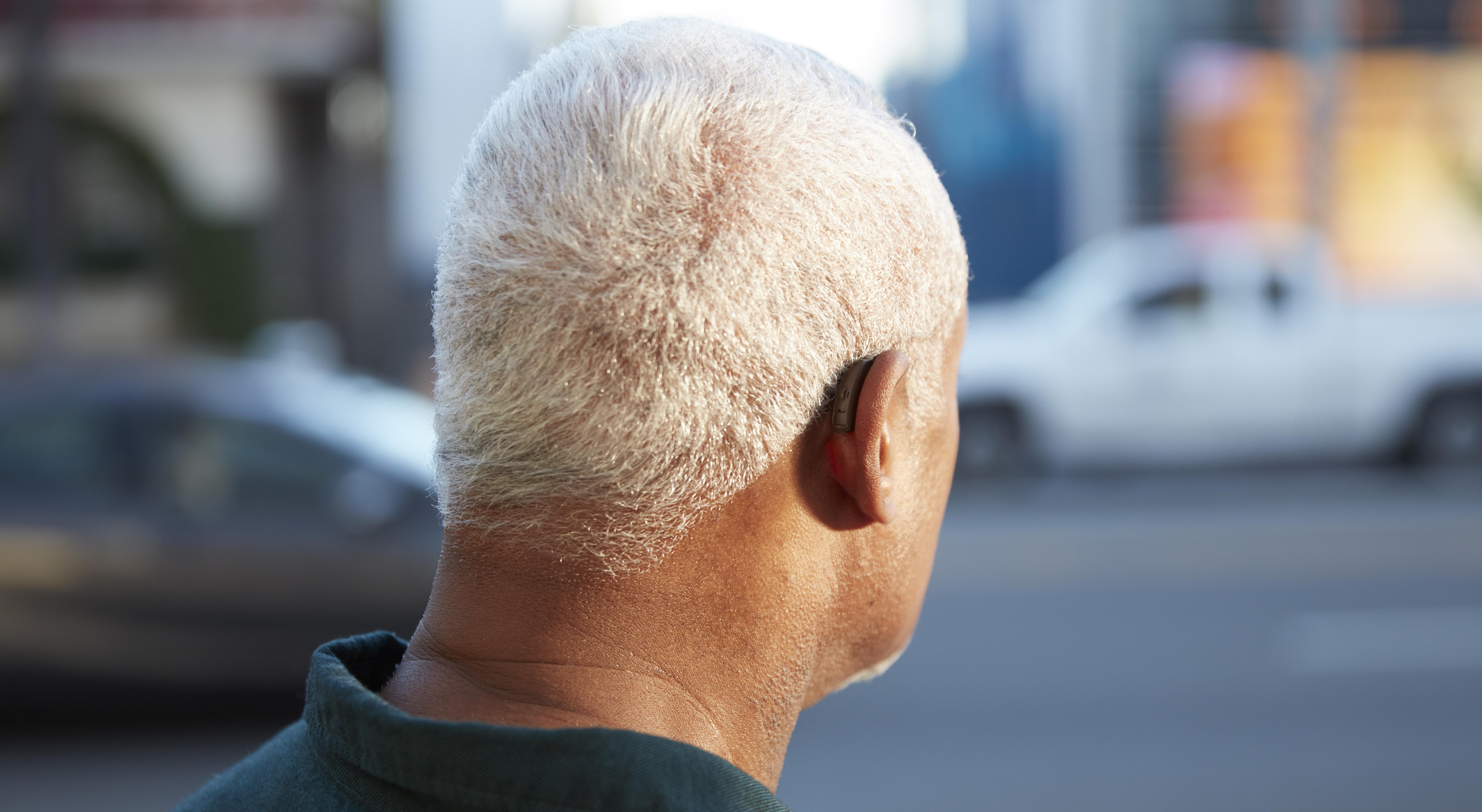 Man wearing ReSound LiNX2 hearing aid BTE. Back view.