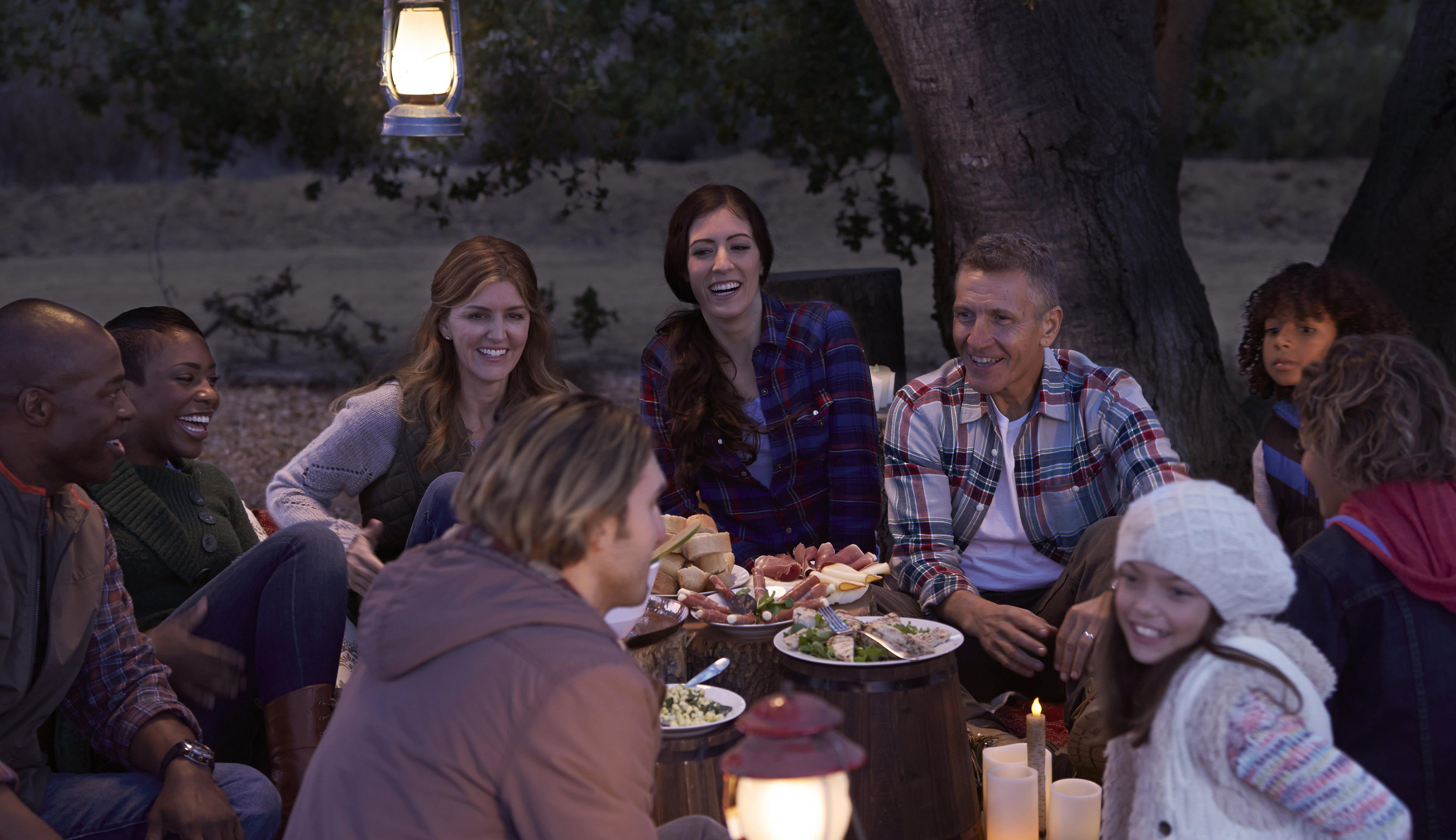Man with hearing loss in a noisy environment: picnic with family.