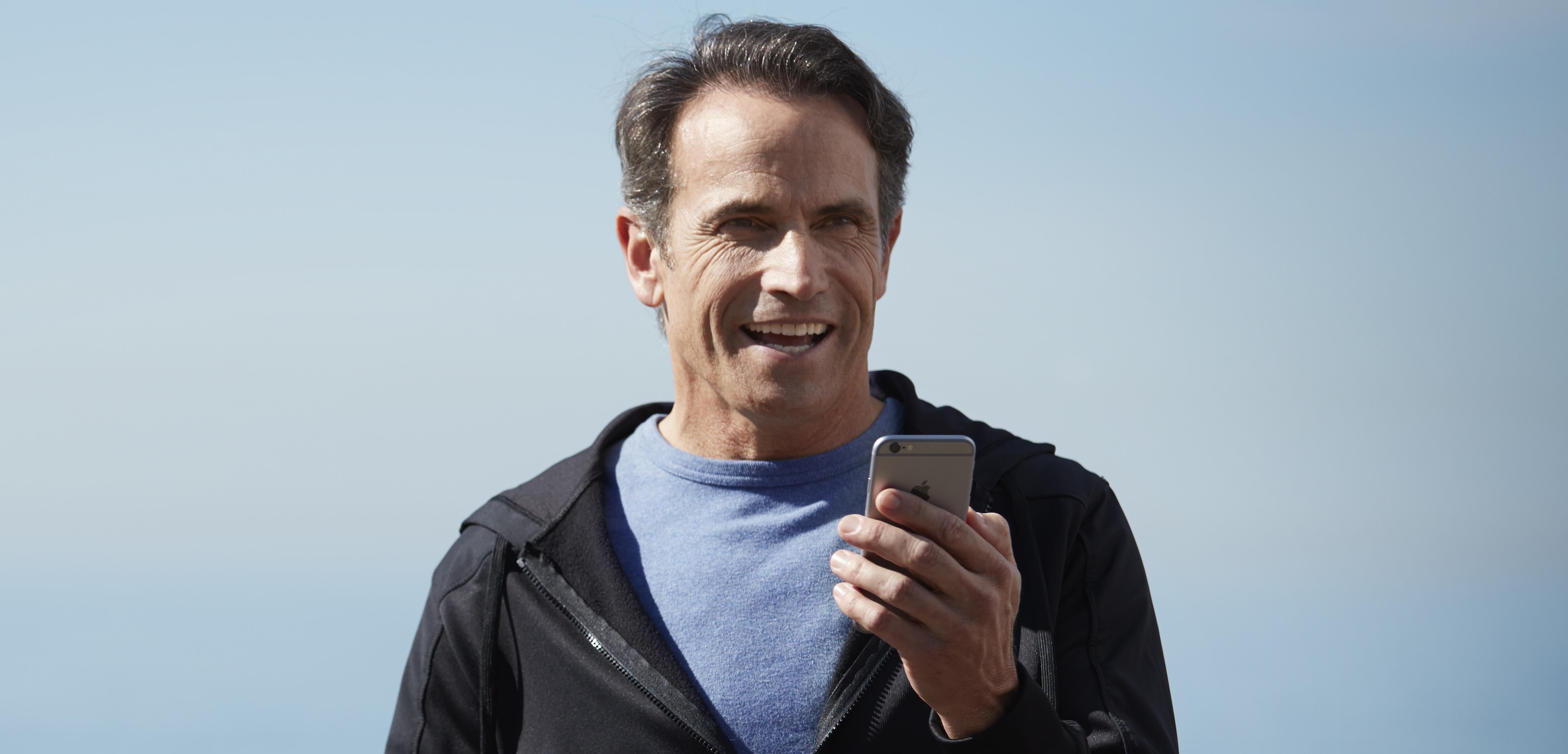 Young man pairing his ReSound hearing aids with a smartphone.