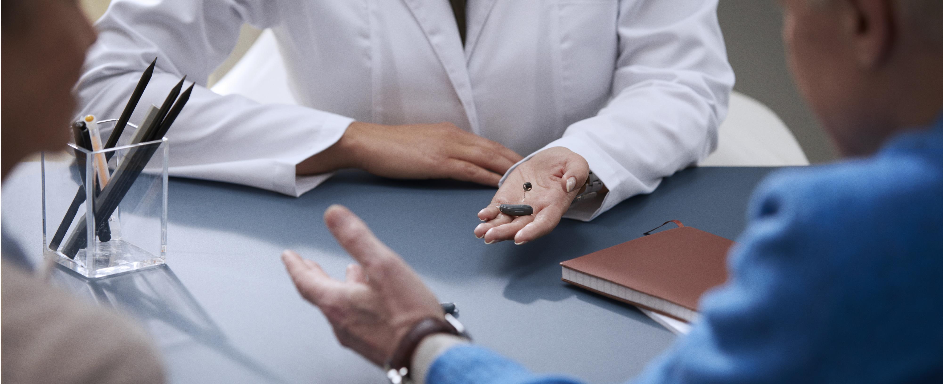 ReSound hearing care professional interacting with a patient during an appointment.