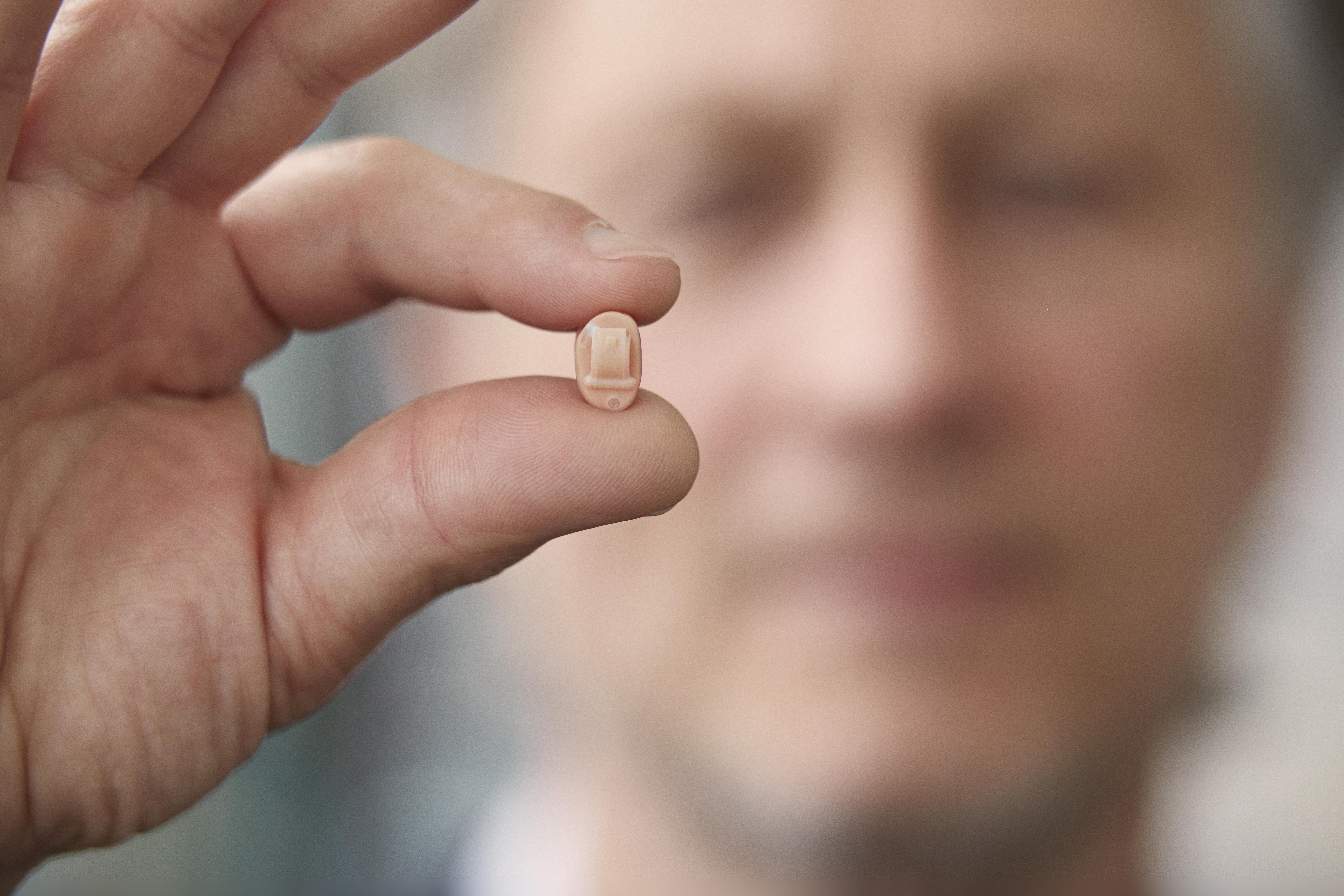 Resound Enya hearing aid in hand