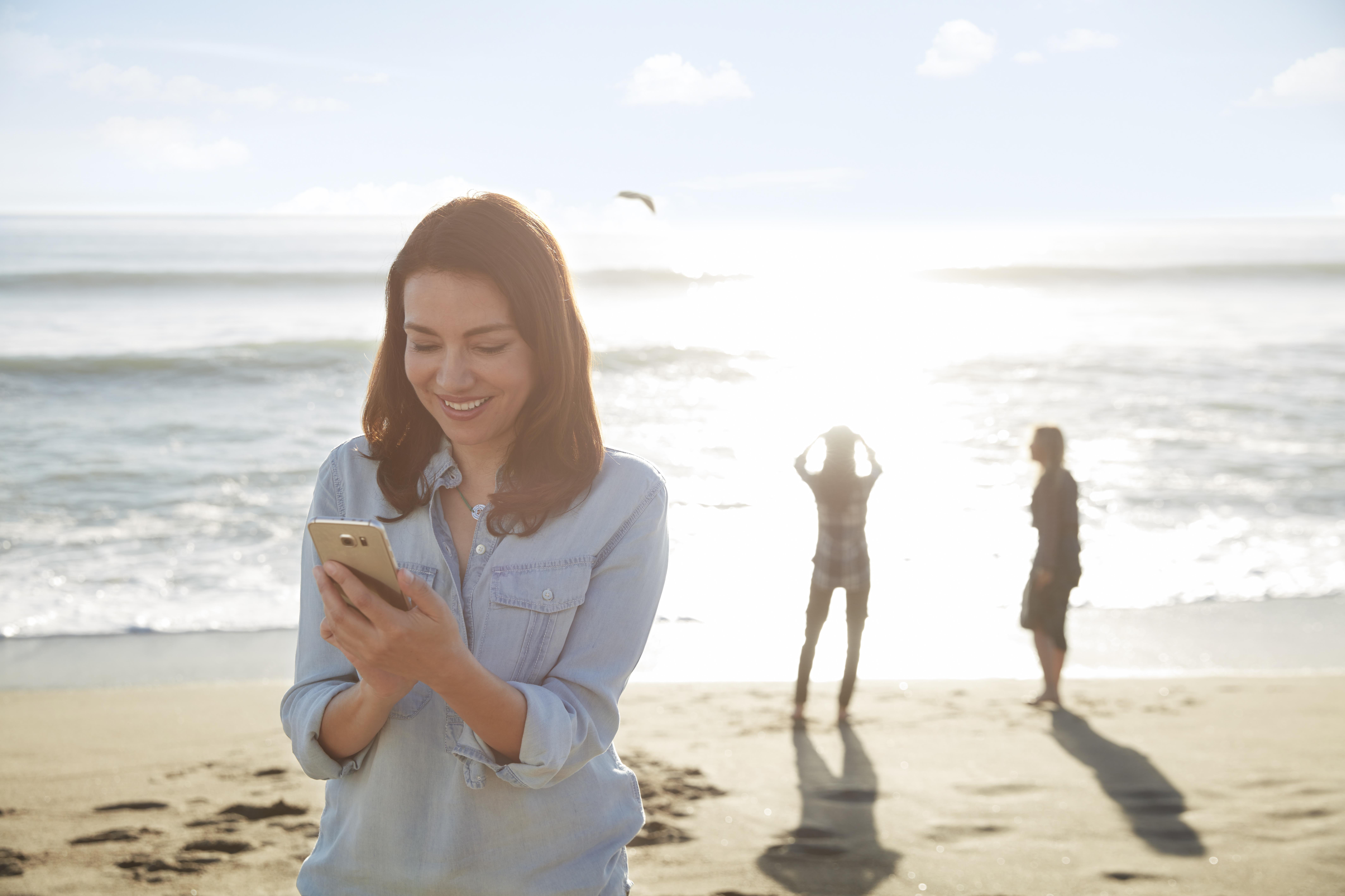 Woman on beach using Resound LiNX 3D app