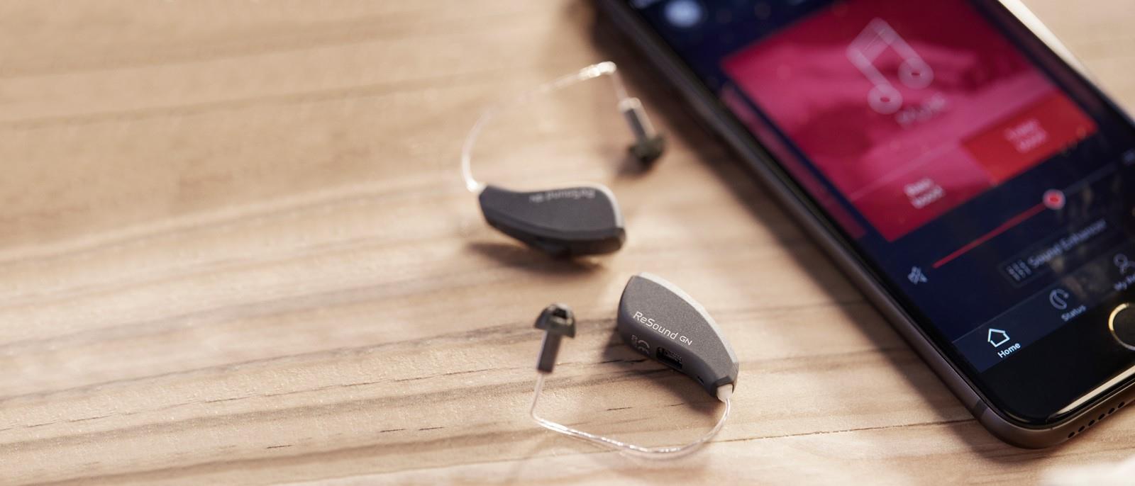 ReSound Smart 3D app next to ReSound LiNX Quattro hearing aids